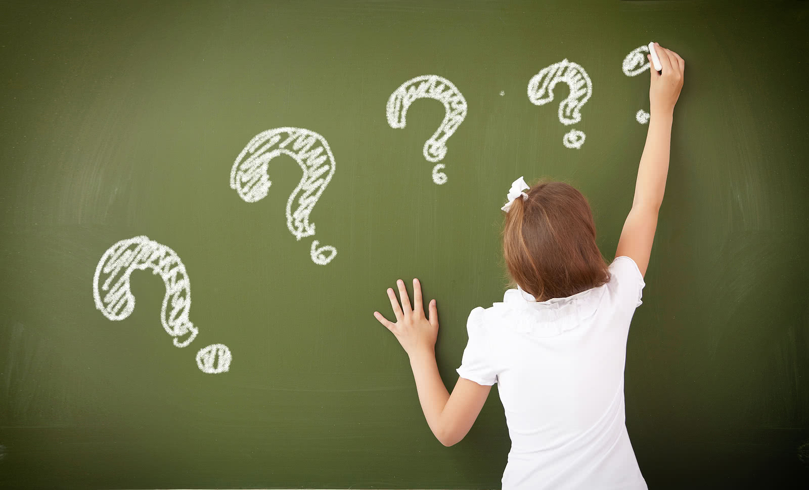 Schoolgirl standing near blackboard The new tax law changes may help you put more money back into your business.