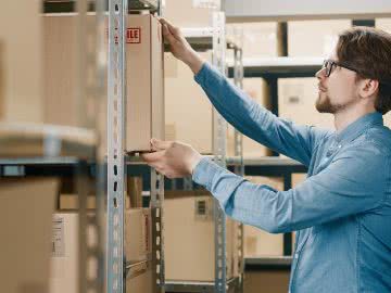 Warehouse working restocks the shelves using Amazon lending