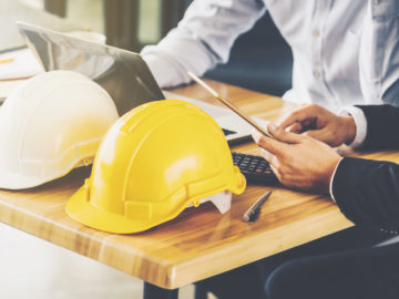 Construction business owners working on their cash flow management plan.